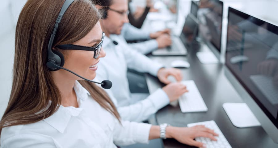 Monitoring specialist at a keyboard in a call center